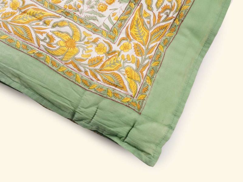 A quilt with a timeless design handprinted in the Jardin du Soleil print. The quilt blanket can be used on top of a duvet or on a summer sheet for extra warmth.