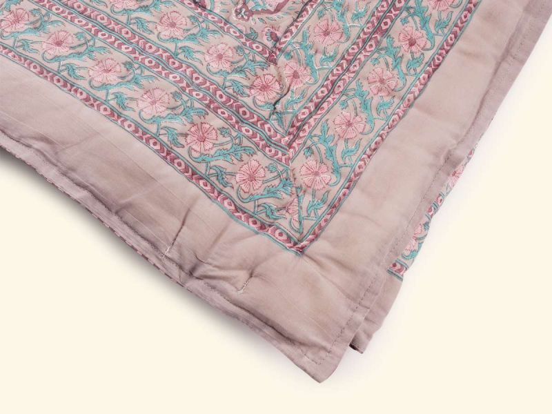 A quilt with a timeless design handprinted in the Pink Paisley print. The quilt blanket can be used on top of a duvet or on a summer sheet for extra warmth.