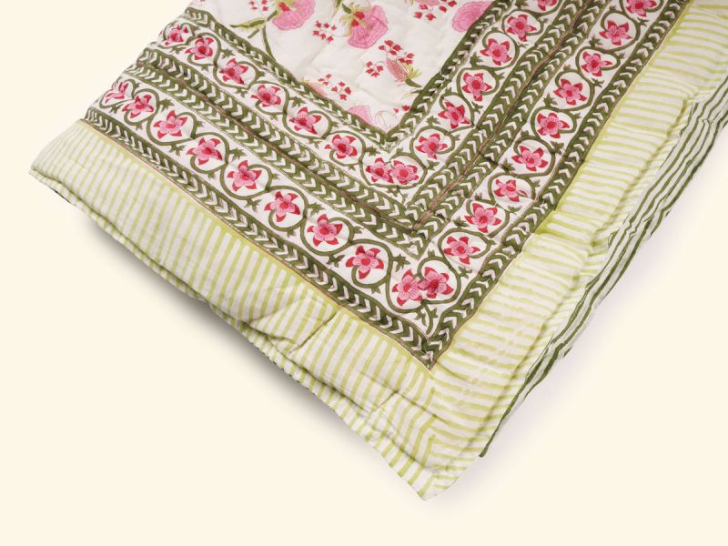 A quilt with a timeless design handprinted in the Pink Lily print. The quilt blanket can be used on top of a duvet or on a summer sheet for extra warmth.