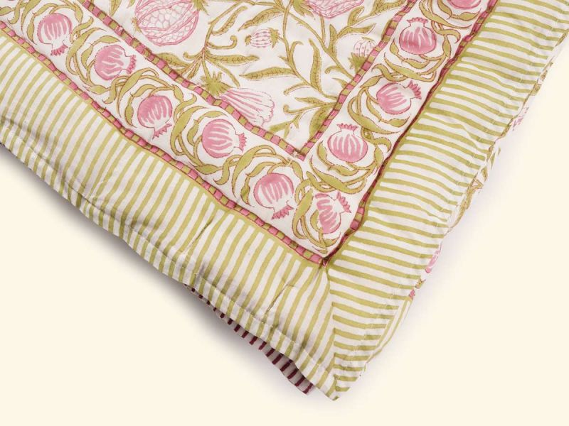A quilt with a timeless design handprinted in the Pomegranate print. The quilt blanket can be used on top of a duvet or on a summer sheet for extra warmth.
